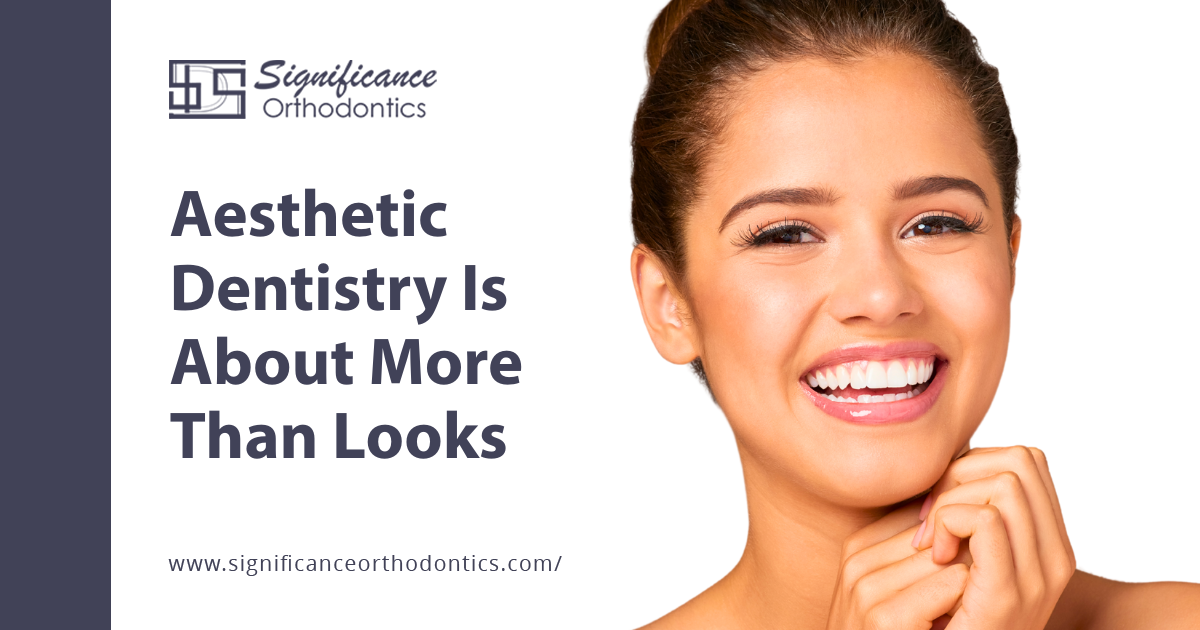 Aesthetic Dentistry Is About More Than Looks 4 metal braces smiling woman clasping hands under chin